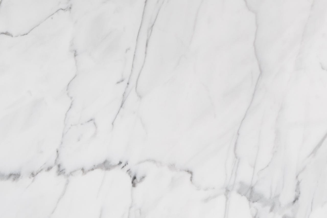 A detailed close-up of white marble's natural veins and elegant texture, ideal for design projects.