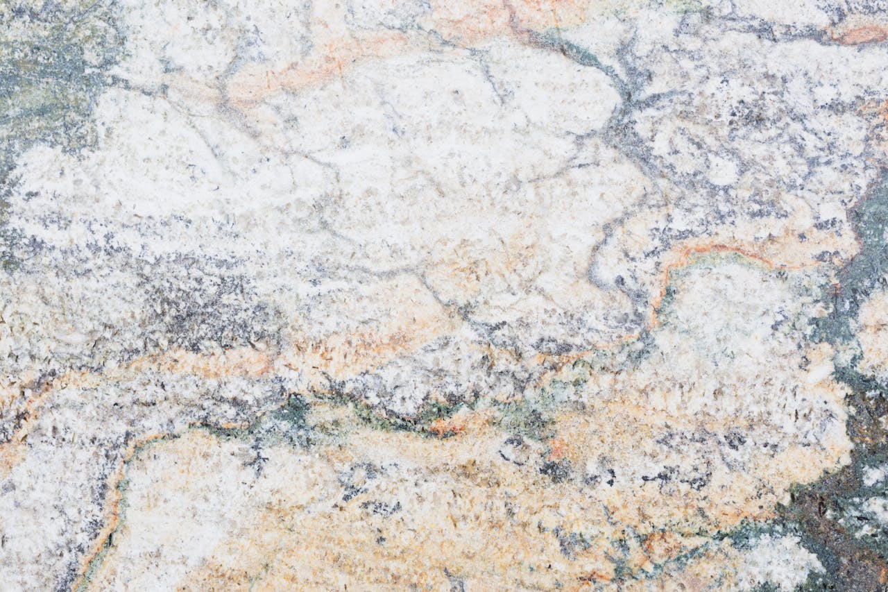Close-up of textured marble surface showcasing unique patterns and earthy tones, ideal for design backgrounds.