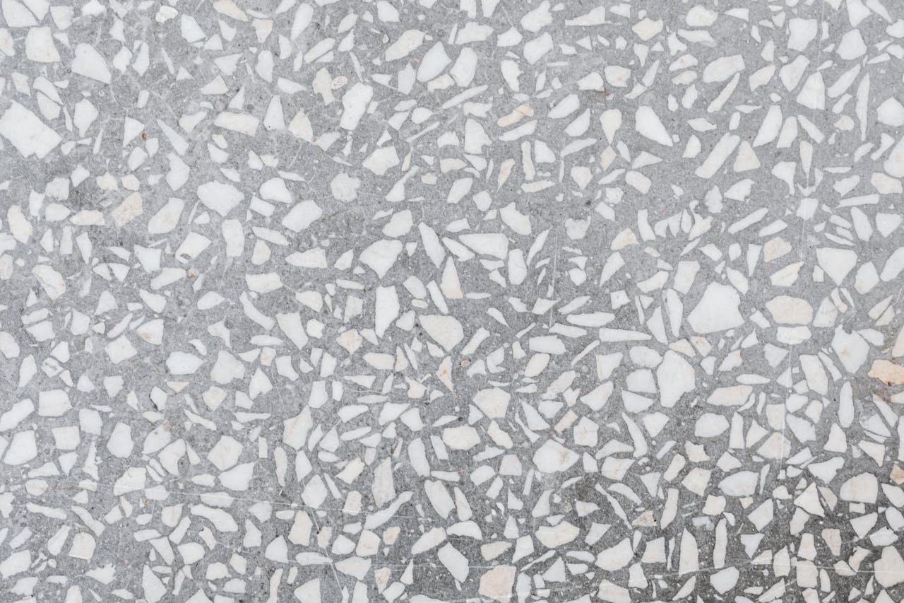 High-resolution image of a classic terrazzo stone texture with white and gray patterns.