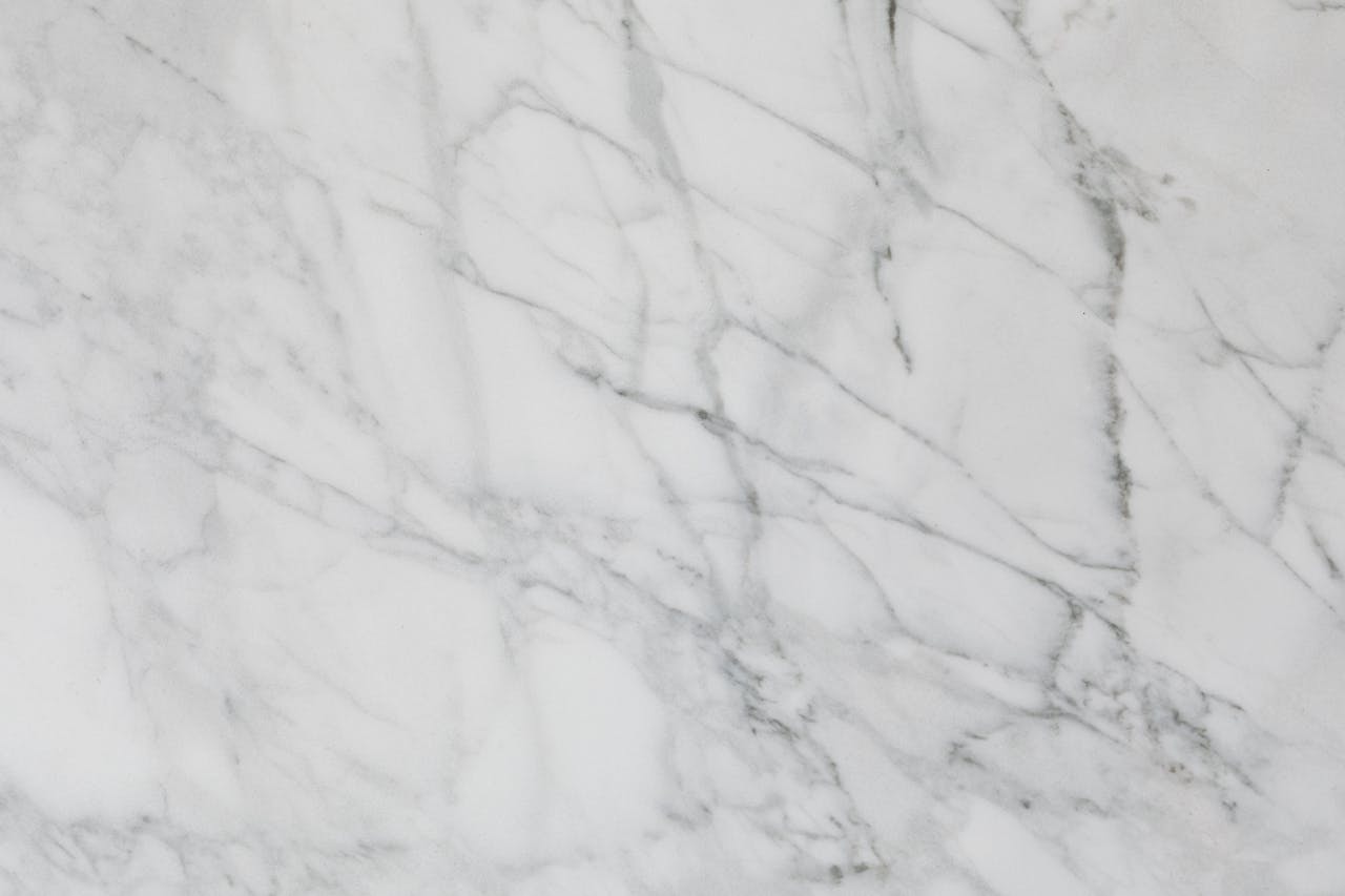 Detailed close-up of white marble texture showcases natural stone patterns with subtle elegance.