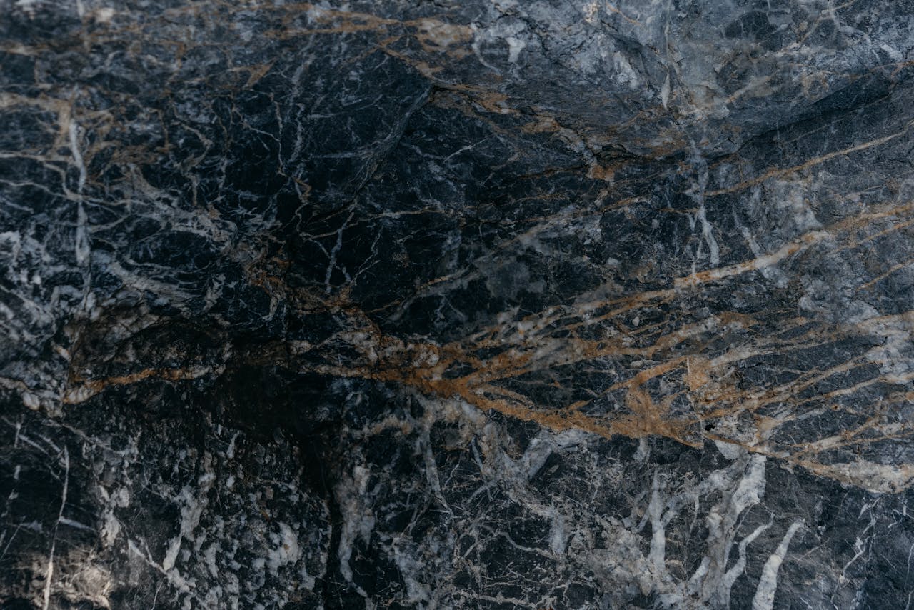 Close-up of a richly textured stone surface with intricate patterns and colors.