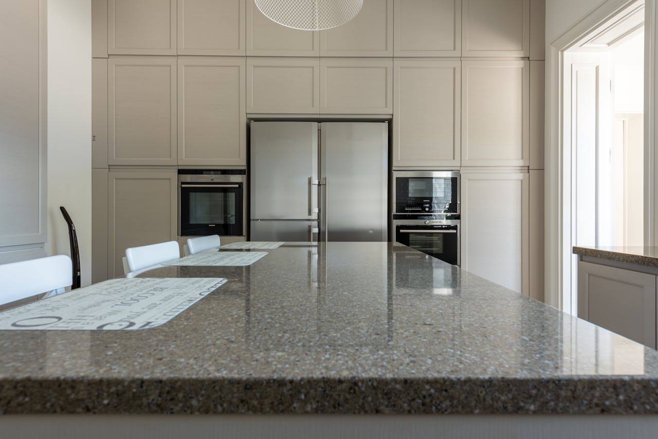 Sleek modern kitchen featuring granite countertops and stainless steel appliances.